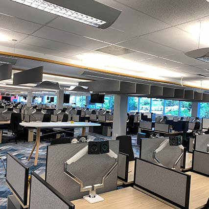 An empty office with multiple cubicles in view.
