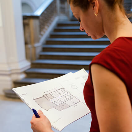 A person reading over an engineering diagram.